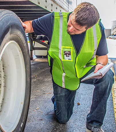 Driver Inspecting vehicle in SAFEGEAR PPE